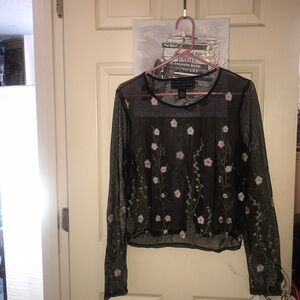 See-through mesh like black shirt with pink embroidered flowers with stems